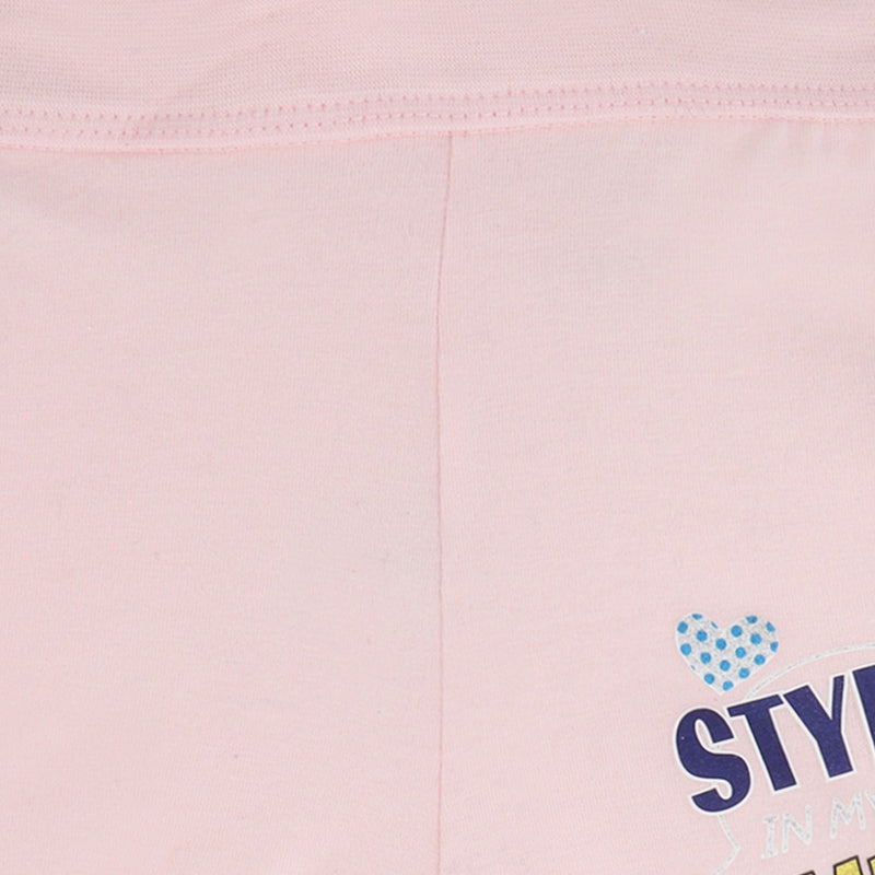 Close-up of light pink kids innerwear with blue polka dot heart and printed text detail