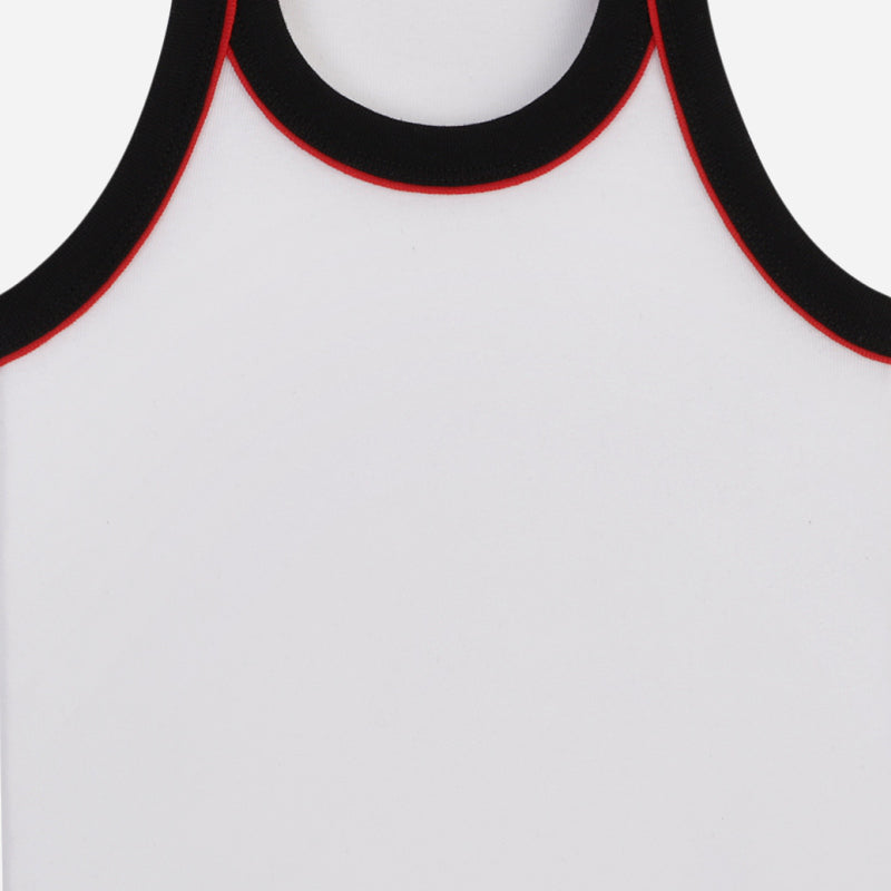 White sleeveless kids vest with black and red trim, close-up of neckline and armholes