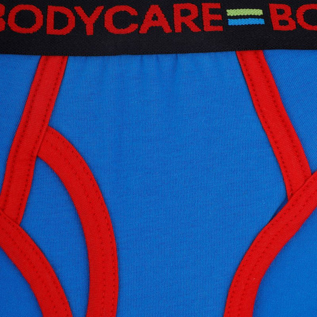 Close-up of blue boys' underwear with red trim and black elastic waistband with red text