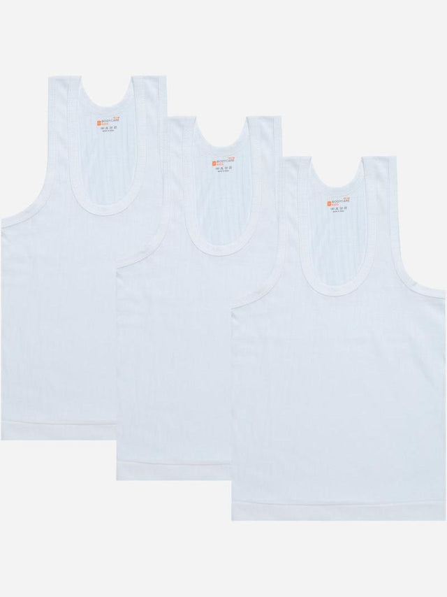 Set of three white sleeveless kids innerwear vests, front view on plain background