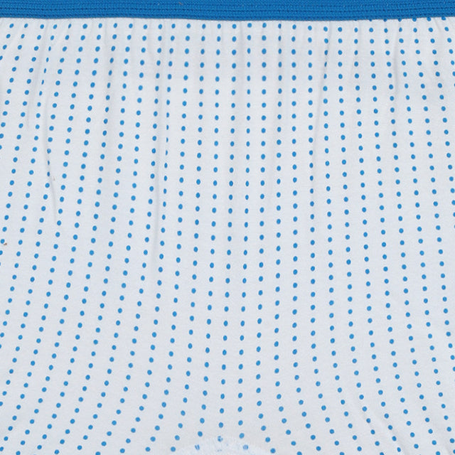 Closeup of kids' white innerwear with blue polka dot pattern and blue elastic waistband.