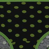 Black kids underwear with green polka dots and green trim, close-up view