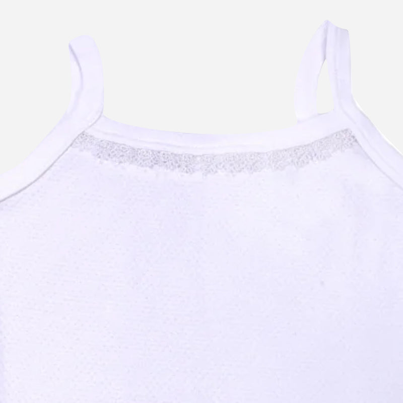 Close-up of white kids camisole with lace detail and thin shoulder straps on plain background