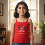 Smiling girl wearing red Minnie Mouse print camisole for kids in a cozy indoor setting.