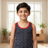 Smiling boy in printed sleeveless vest with red trim, kids innerwear, indoor setting